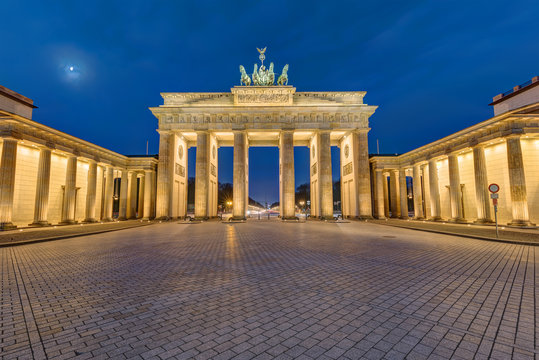 The famous Brandenburg Gate in Berlin illuminated at dawn