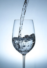 Pouring pure drinking Water into Glass