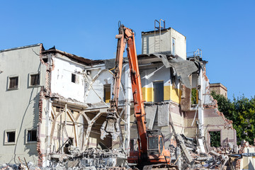 demolition of industrial building. excavator working at construction site. 