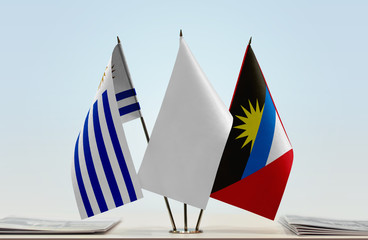 Flags of Uruguay and Antigua and Barbuda with a white flag in the middle