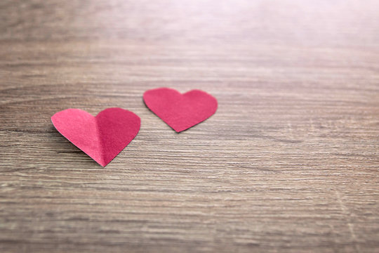 red paper couple hearts on wood, day of love 