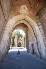 gate in turret of Alcantara bridge, landmark and monument from ancient arab age, in Toledo city, Spain, Europe. Vertical
