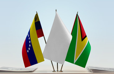 Flags of Venezuela and Guyana with a white flag in the middle