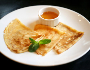 Photo of macro tasty bright pancakes with honey