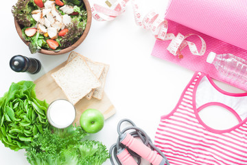 Top view of Healthy lifestyle concept, sport equipments and fresh foods on white background