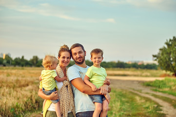young married couple with children on a country walk