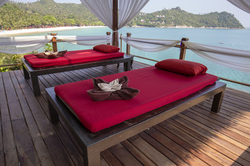 Naklejka premium Massage table overlooking the sea. Spa massage room on the beach in Thailand