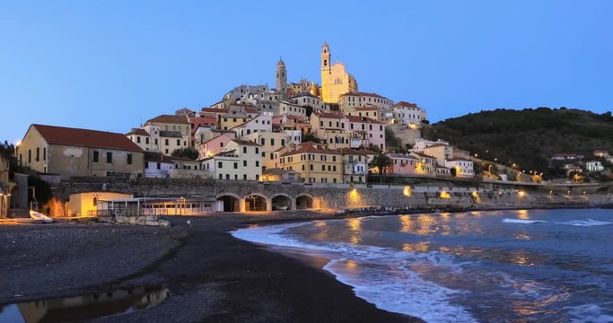 Cervo - medieval hilltop town at dusk, Liguria, Italy (zoom in view from seaside)

