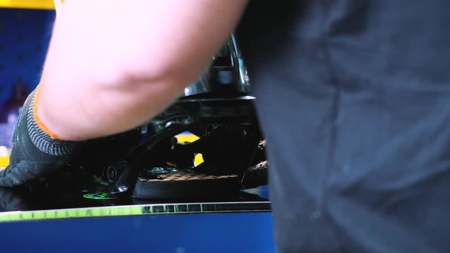 snowboarder fastens the mount to the snowboard. Prepares snowboard for winter to use