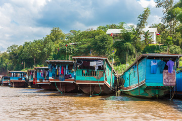 Fototapeta na wymiar Boats near the bank of the river Nam Khan in Luang Prabang, Laos. Copy space for text.