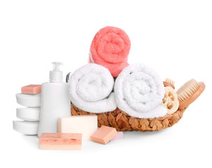 Obraz na płótnie Canvas Basket with soft towels and toiletries on white background