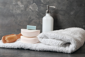 Obraz na płótnie Canvas Soft towel and bath accessories on table