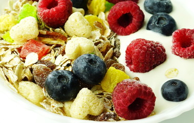 Healthy breakfast. Fresh granola, muesli with yogurt and berries on white wooden background.Close up
