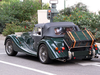 Retro car convertible Morgan stands at a traffic light in Monaco. Retro adventure. Europe....