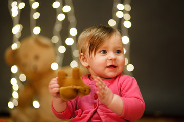 Fototapeta na wymiar Portrait of a little girl in a pink dress in the studio. Lights Backgrounds