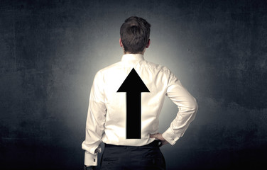 Young businessman standing with arrow on his back