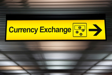 sign currency exchange at the airport with money currency icon and arrow for direction to currency exchange booth counter service for tourist