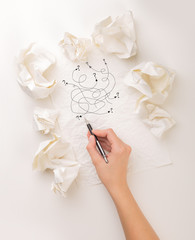 Writing hand in crumpled paper