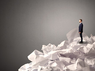 Businessman standing on crumpled paper