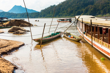 Boats near the bank of the river Nam Khan in Luang Prabang, Laos. Copy space for text.