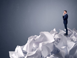 Businessman standing on crumpled paper