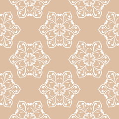 Fototapeta na wymiar White floral ornament on beige background. Seamless pattern