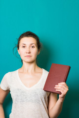 beautiful brunette girl with book in hand