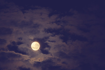 Naklejka na ściany i meble Full Moon on a dark sky with clouds.