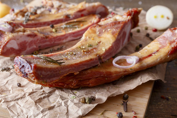 Appetizing smoked pork ribs on a wooden surface