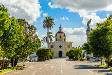 Fototapeta na wymiar Cristobal colon catholic cemetery chapel, with road and alley in the foreground, Vedado, Havana, Cuba