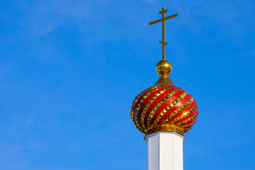 a multi-colored tower of the Orthodox Church in the Russian outback, a wooden building