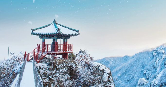 Falling snow at temple in winter. South Korea.