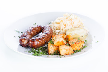 Grilled meat sausages with potatoes and cabbage on a white background