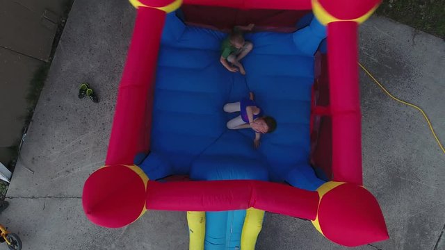 Cute little girl looking up from inside a bouny castle inflatable toy