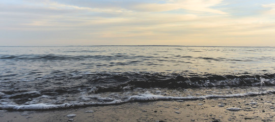 Waves on the coast in motion, in the warm evening light