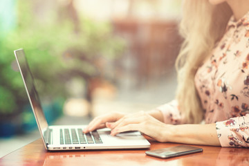 Woman is working on laptop in the cafe