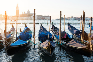 Fototapeta na wymiar Venice classic sunrise view with gondolas on the waves