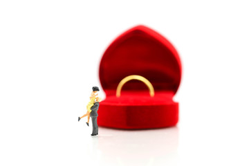 Miniature people : Couple of love with gold ring , love, valentine day concept.