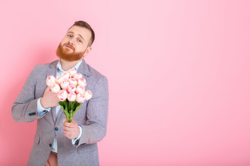 Handsome man holding bouquet of tulips