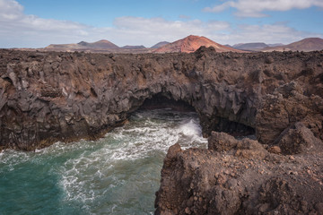 Lanzarote landscape. Los Hervideros coastline, lava caves, cliffs and wavy ocean. No people appears in the scene.