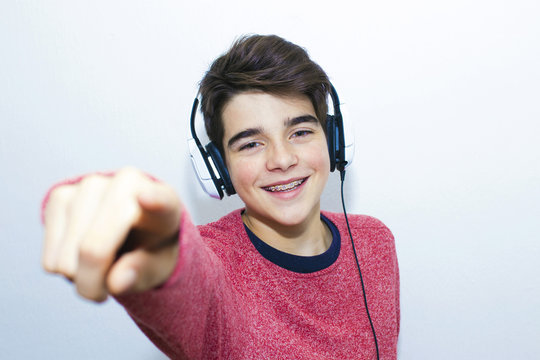teen with headphones dancing on white background
