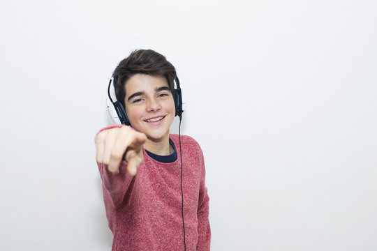 teen with headphones dancing on white background