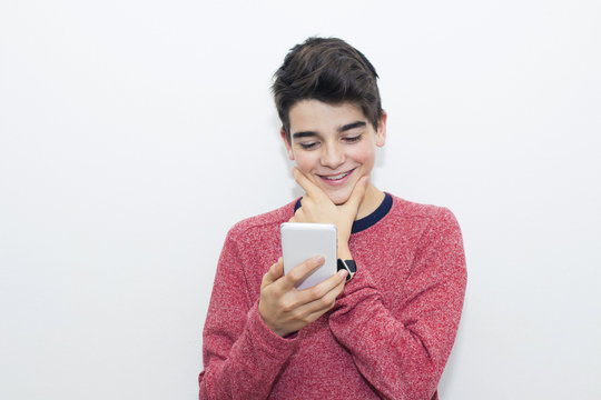 teen smiling watching mobile phone on white background