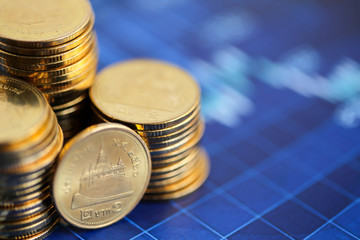 Stack of coins with Finance  graph background.