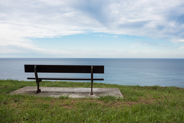 Fototapeta na wymiar Bench with ocean panoramic view