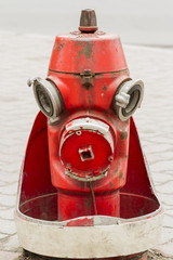 Retro red fire hydrant on the city street