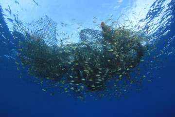 Ghost net. Abandoned fishing net pollution of ocean environment  - obrazy, fototapety, plakaty