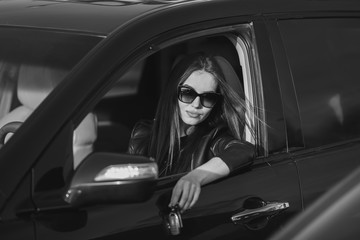 Fototapeta na wymiar Girl in a car in glasses