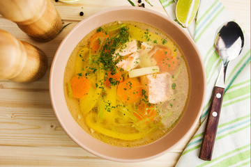 bright vegetable soup with salmon in a ceramic plate - 193102083