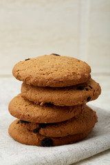 Stack of Chocolate chip cookies on wooden background. Stacked chocolate chip cookies shot with selective focus.